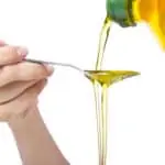 vegetable oil pouring on spoon